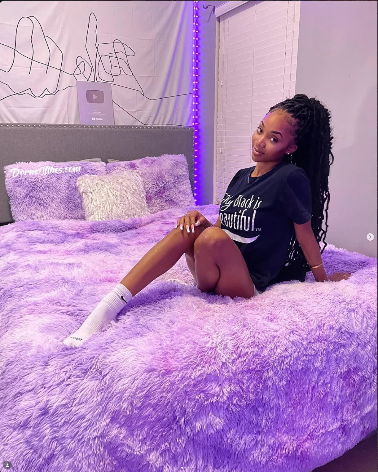 Lavender PLUFFY bedding, a wall tapestry, and purple string lights in a DormVibes bedroom