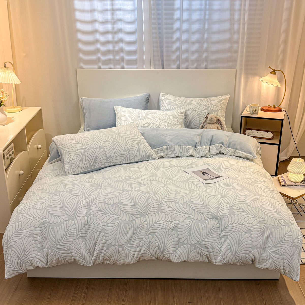Powder blue Fleurie botanical floral bedding on a made bed