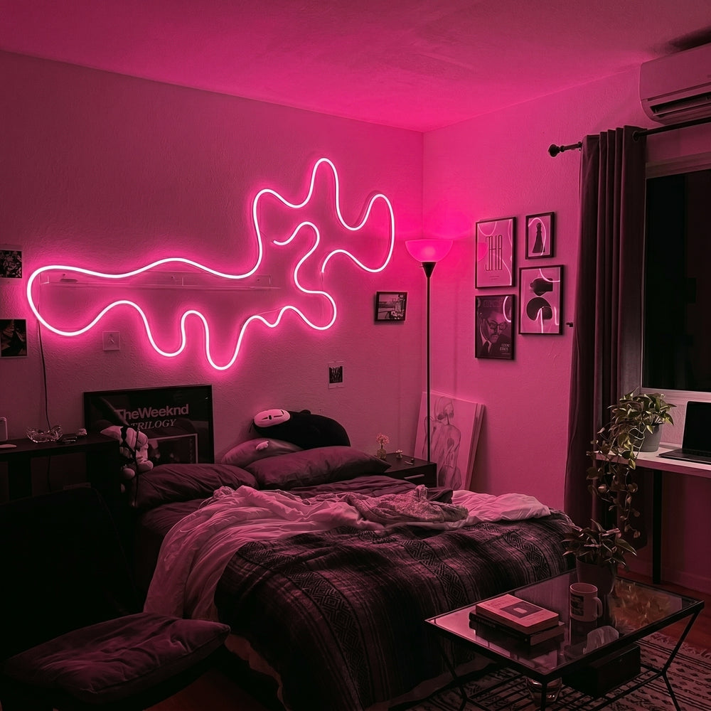Pink neon rope light in a wavy line above a bed