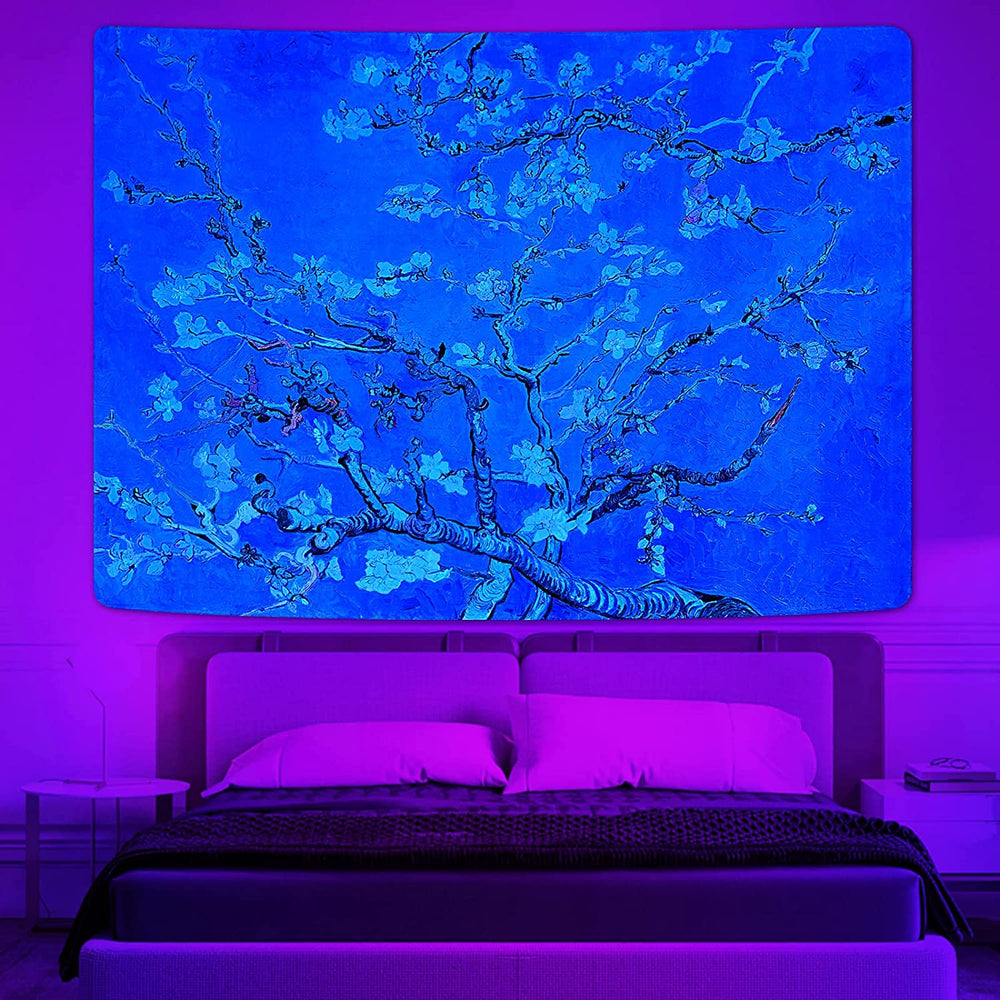 Blue flowering tree tapestry hanging above a bed