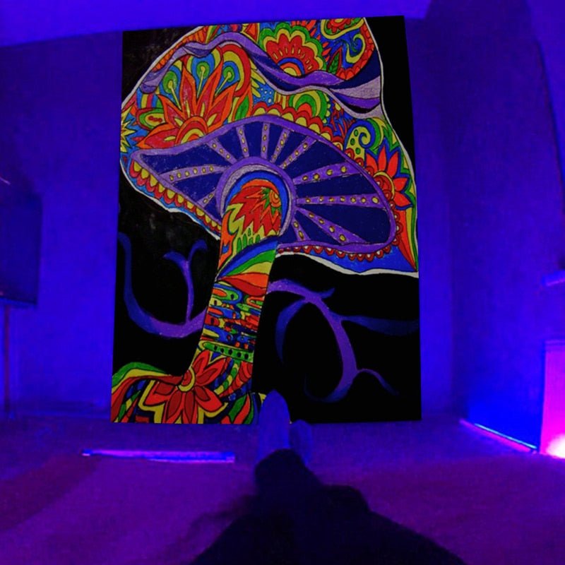 Colorful patterned mushrooms on a black tapestry in a purple-lit room
