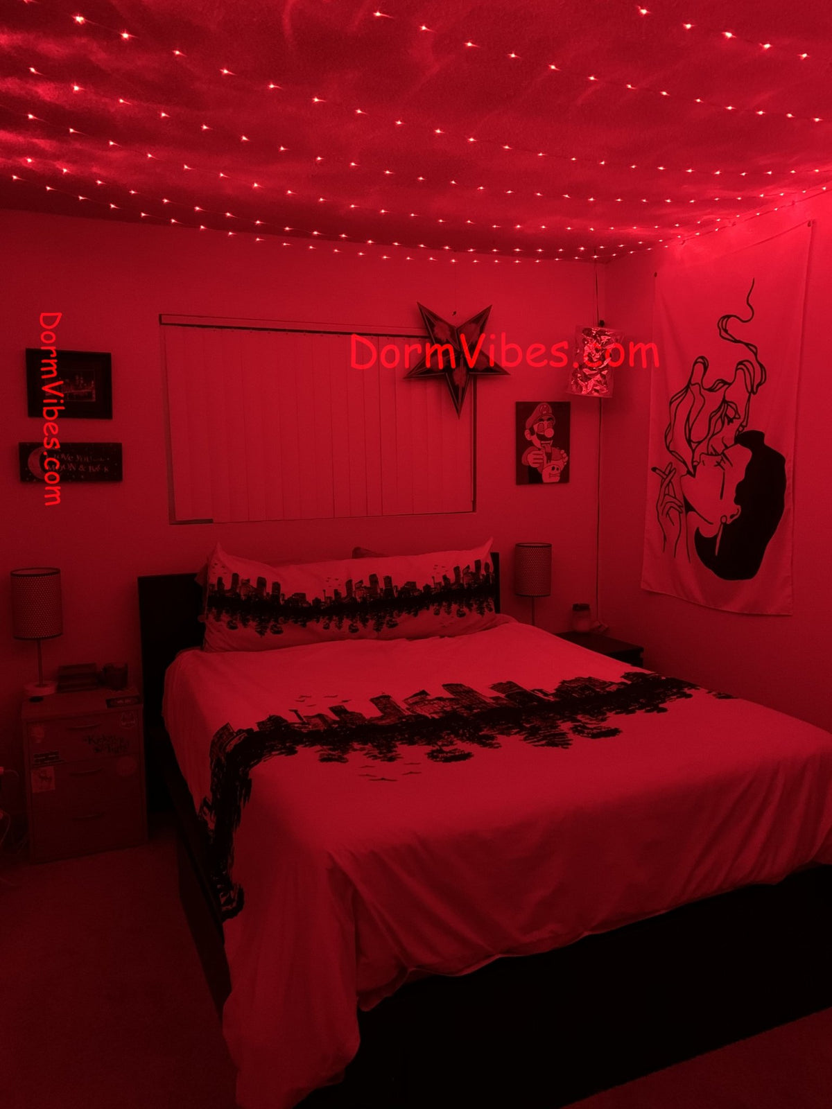 Red ceiling lights above a bed with white patterned bedding