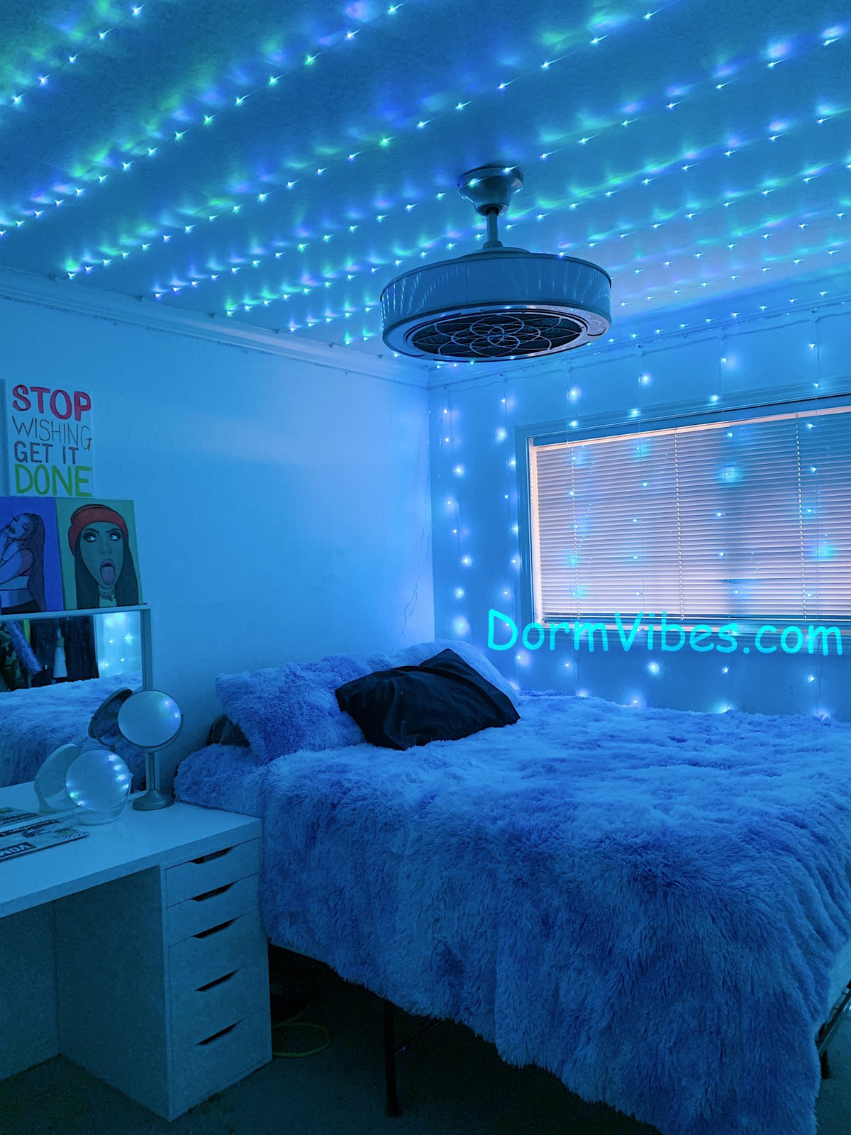Blue ceiling lights around a hanging bedroom light fixture