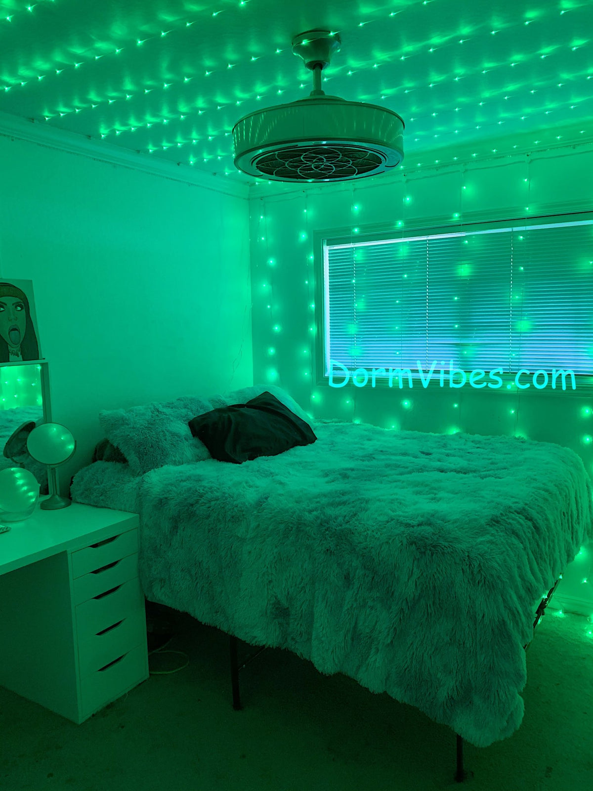 Green ceiling lights above a fluffy bed beside window blinds
