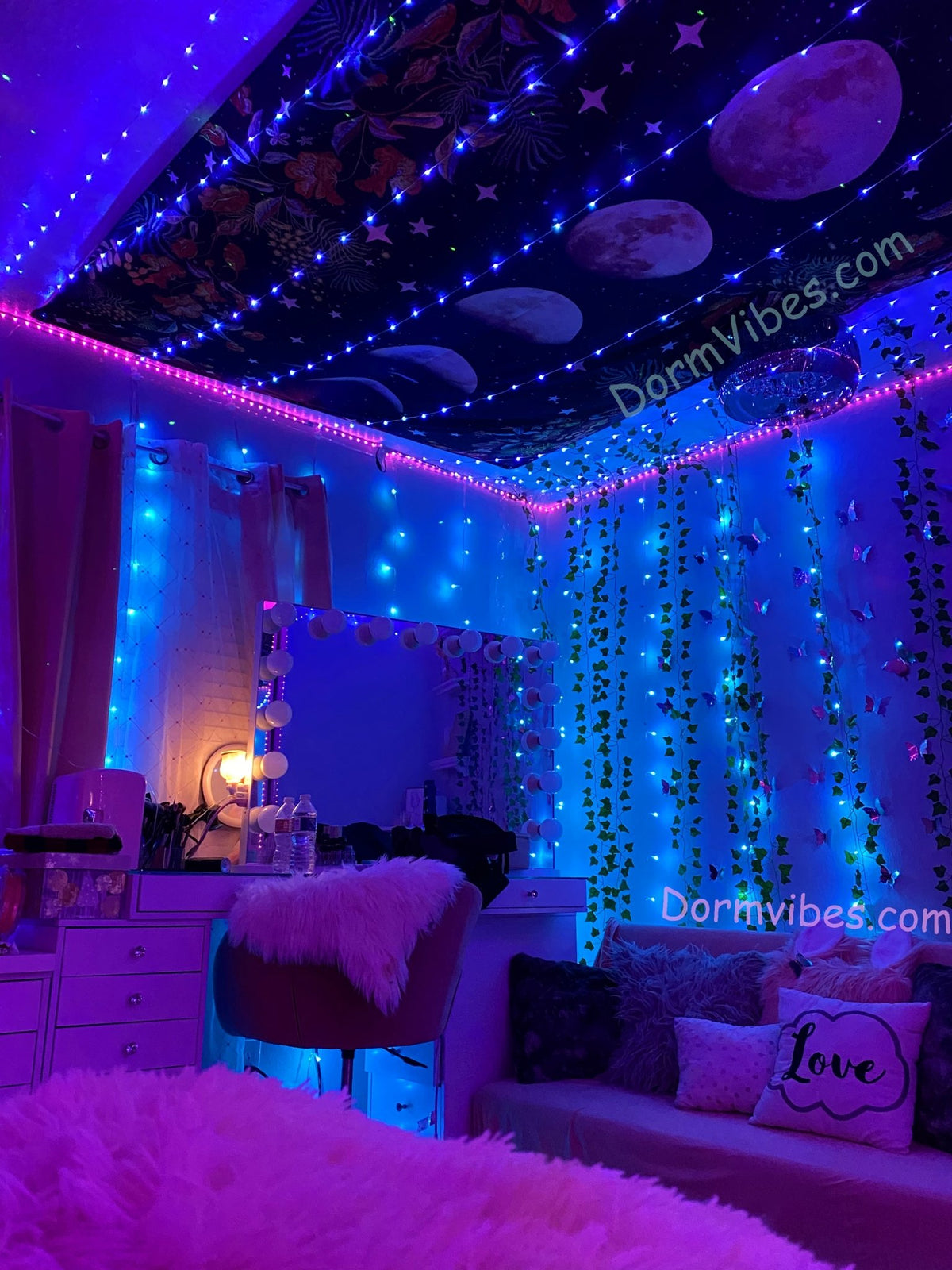 Purple ceiling lights bordering a moon phase ceiling tapestry