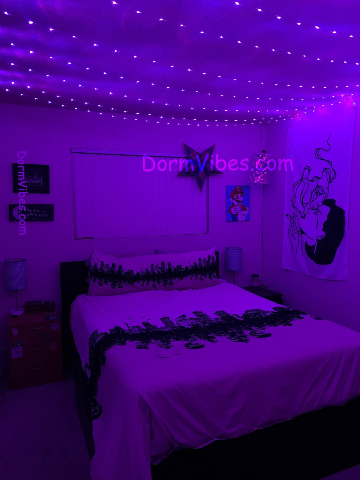 Purple ceiling lights illuminating a bedroom with white patterned bedding