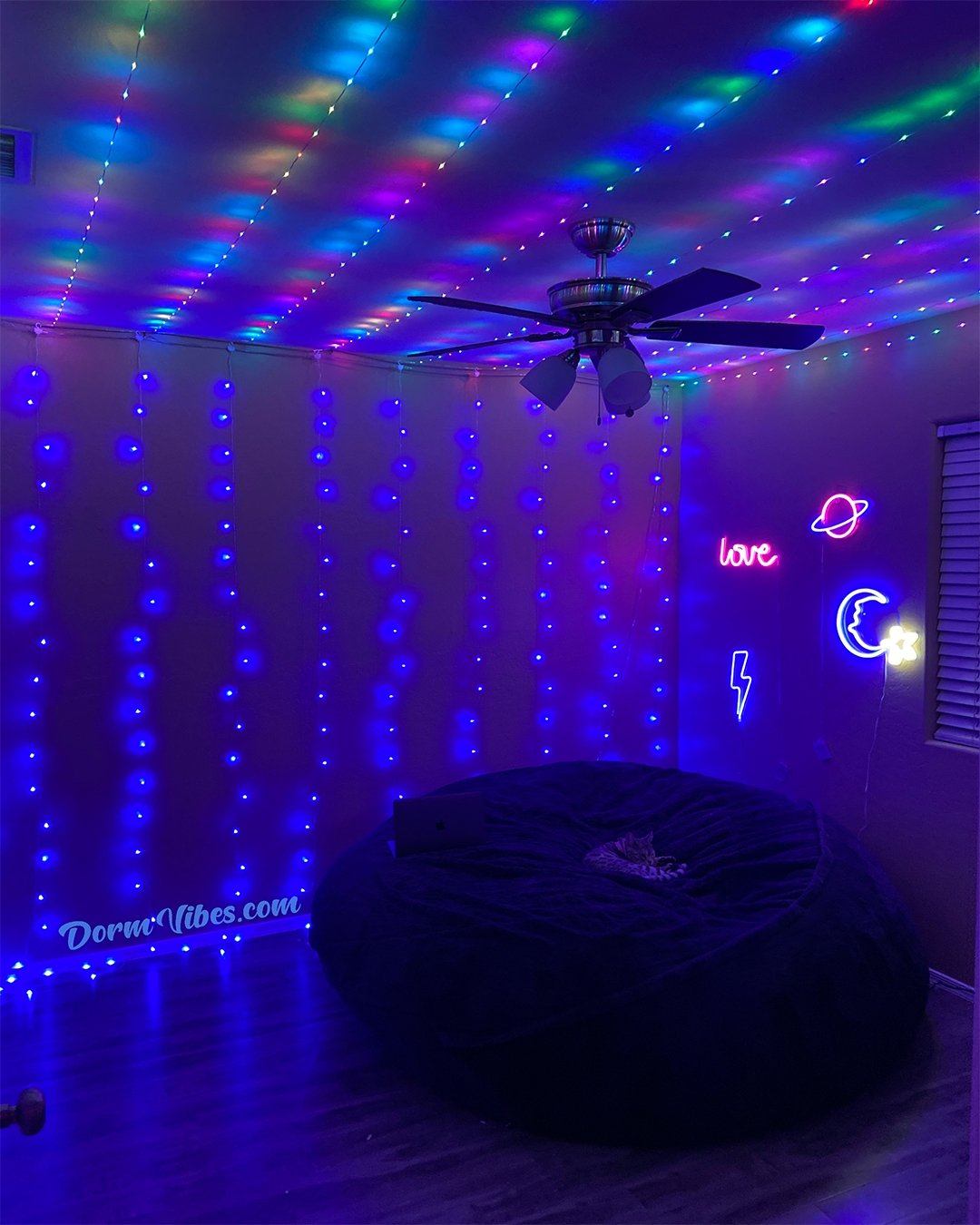 Multicolored ceiling lights above blue wall lights and a round chair