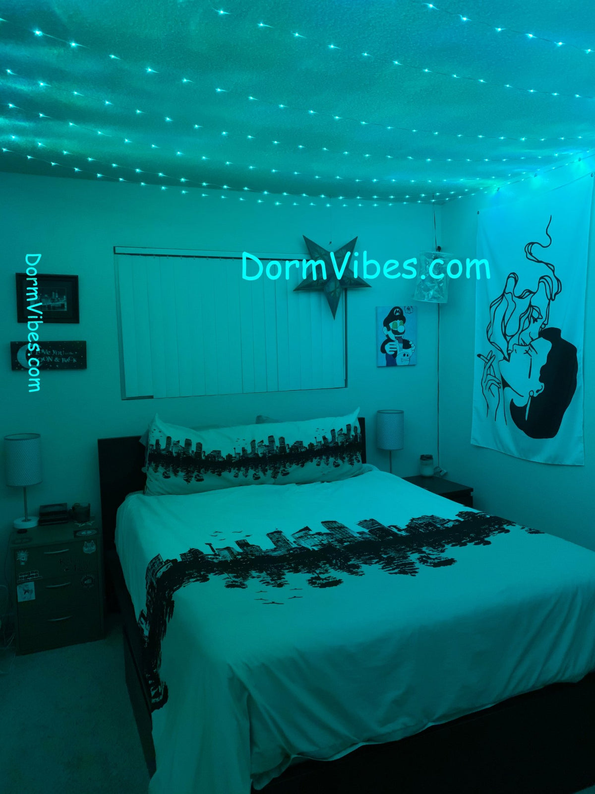 Turquoise ceiling lights above a bed with patterned white bedding