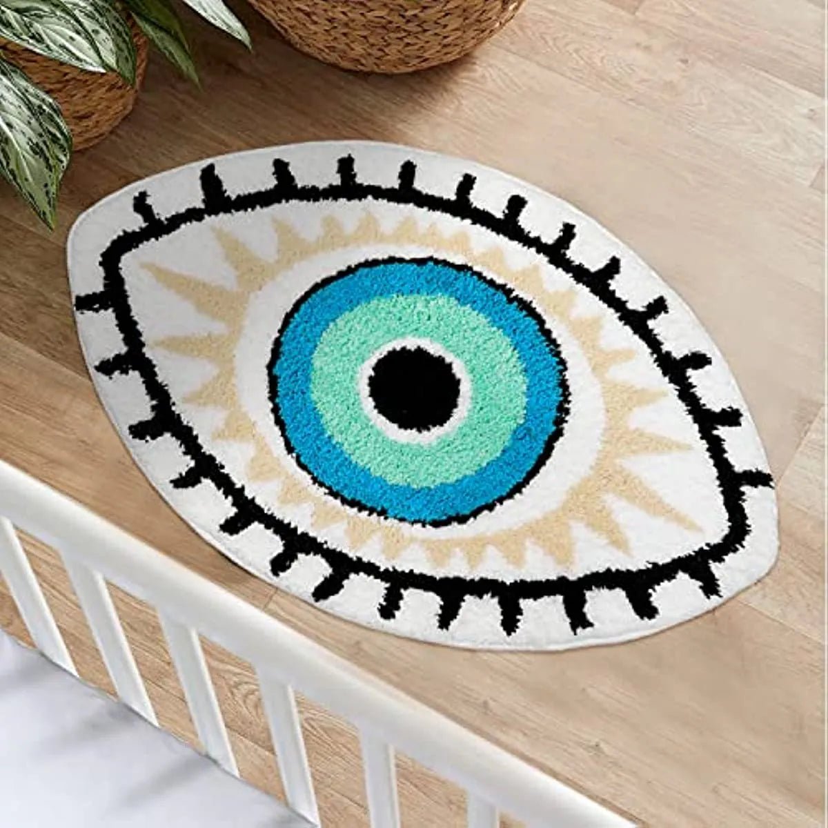 Eye-shaped rug with a blue iris, black lashes and cream border