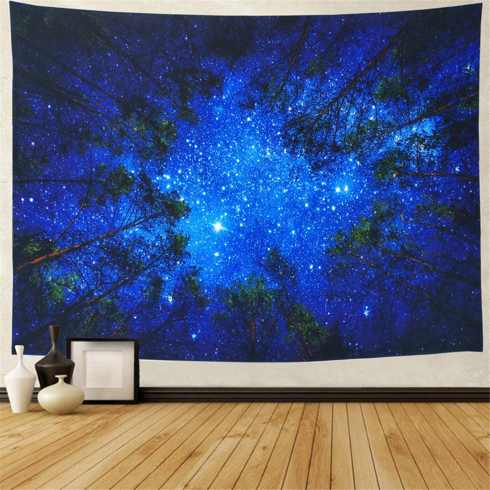 Blue starry-sky tapestry framed by dark forest treetops
