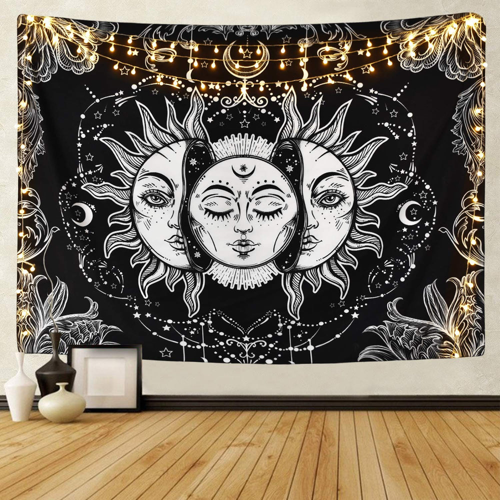 White sun and moon faces on a black tapestry with warm string lights