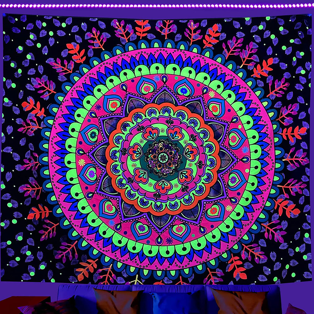 Colorful circular floral mandala tapestry under purple lighting