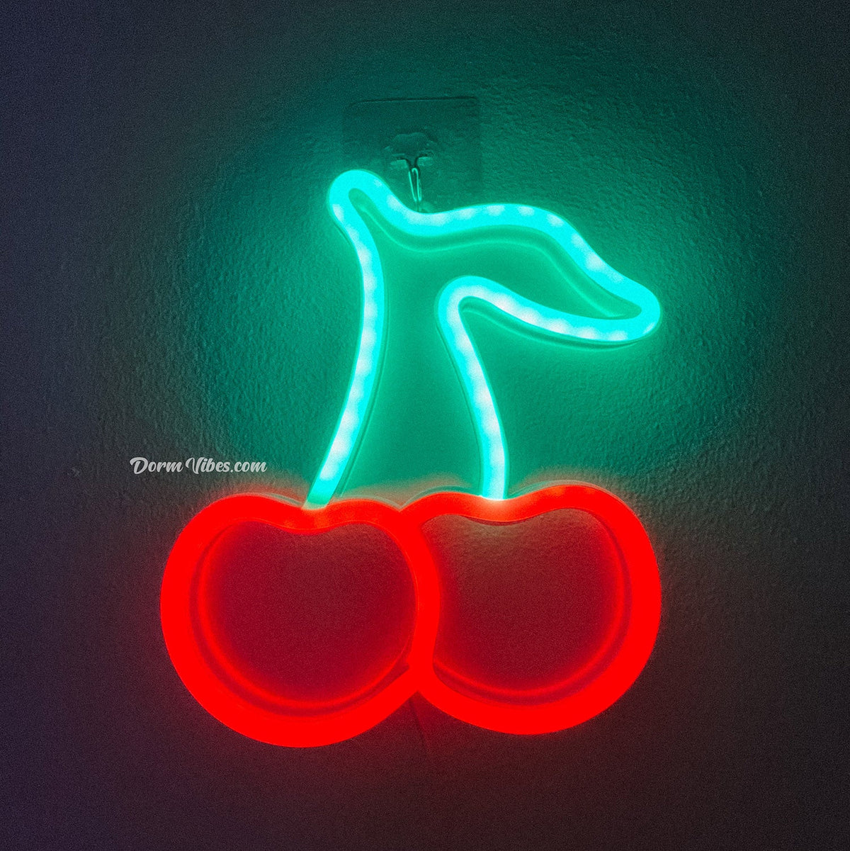 Red and turquoise cherry neon sign mounted on a wall