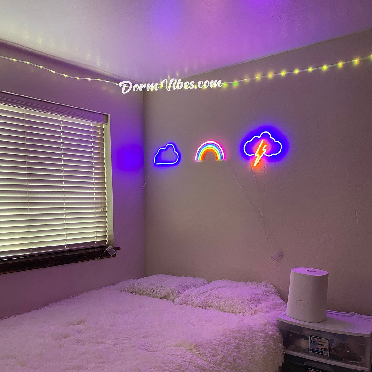 Blue cloud and rainbow signs above a bed beside a window