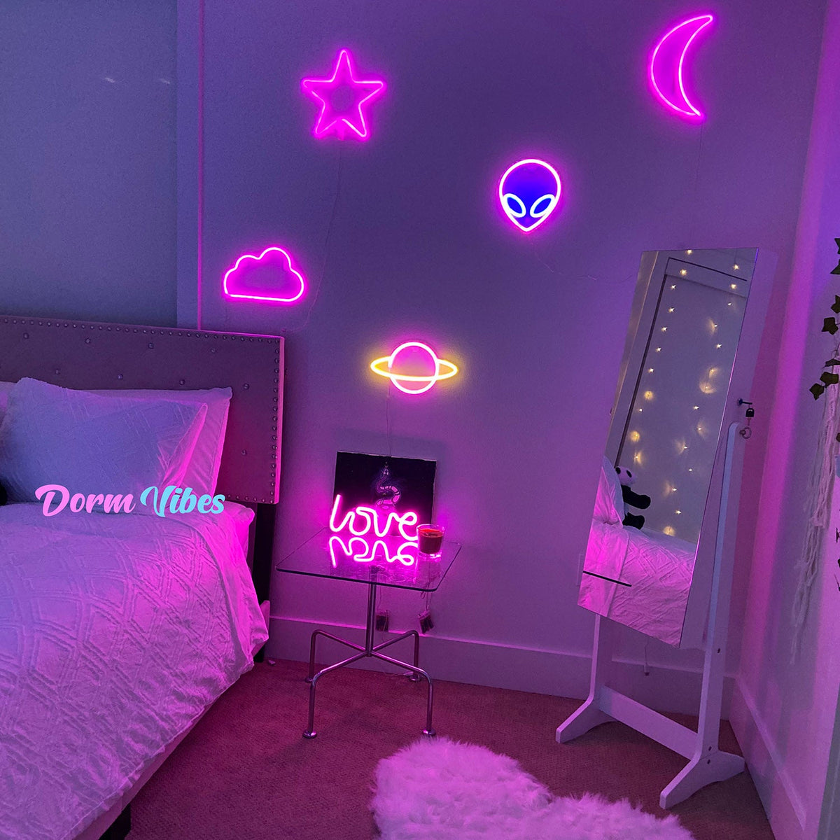 Pink cloud wall sign among neon shapes in a bedroom