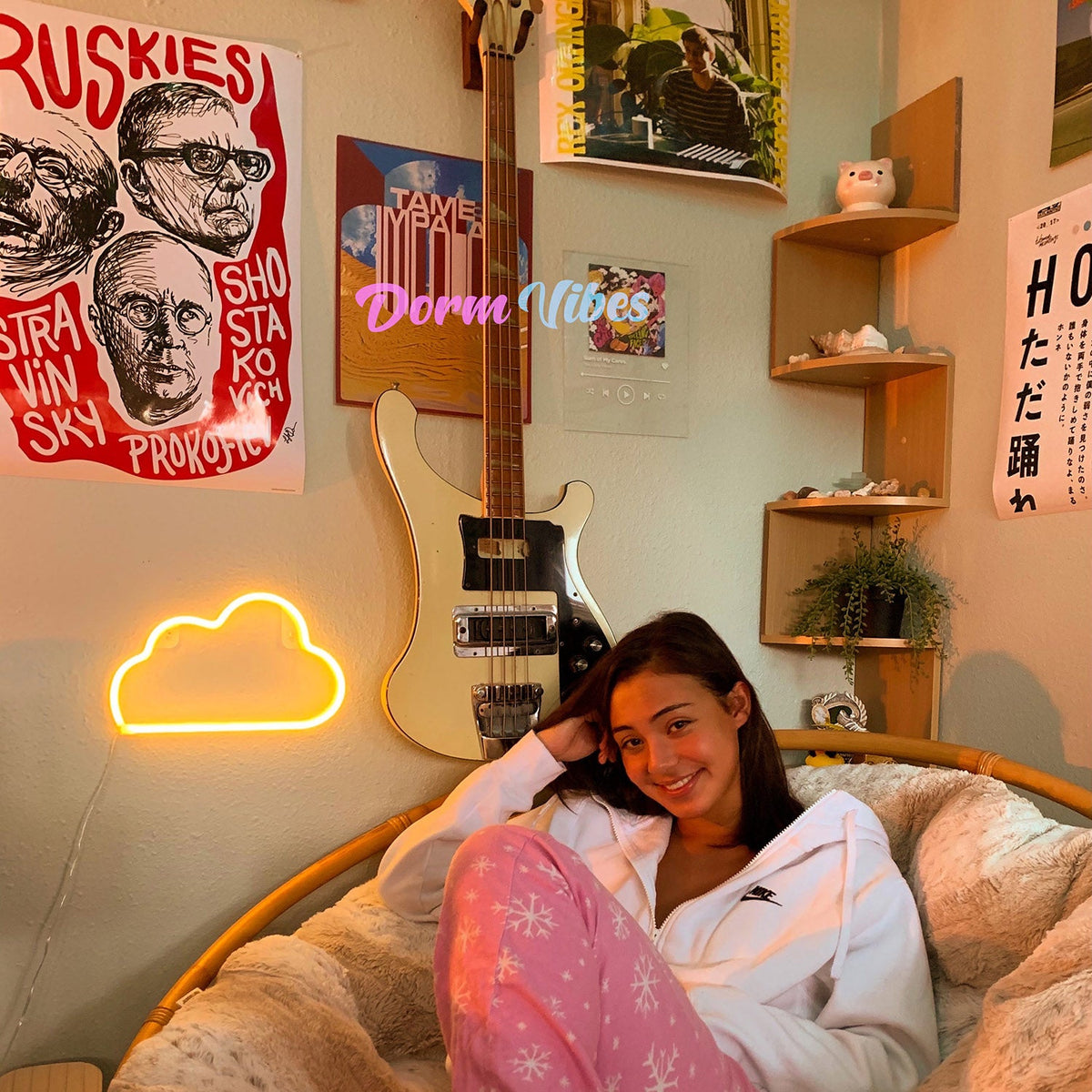 Yellow cloud neon sign beside a guitar above a chair