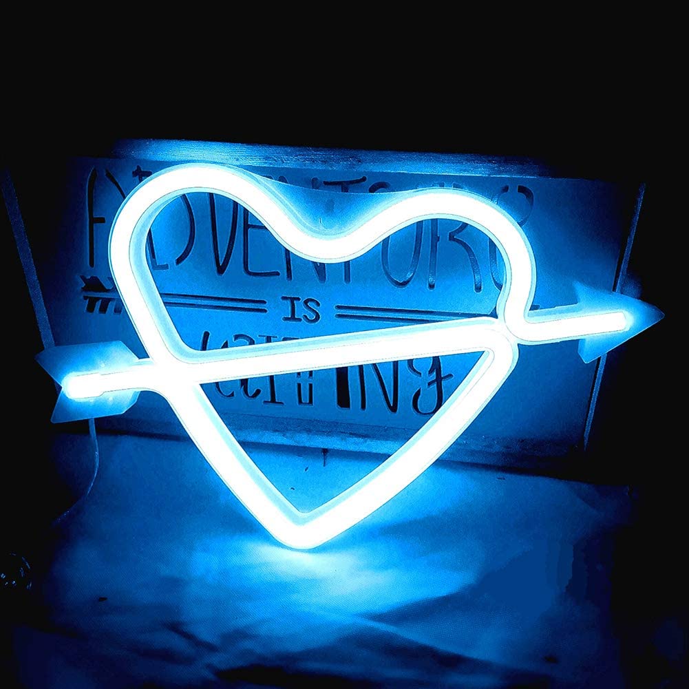 Blue heart-and-arrow neon sign against a dark backdrop