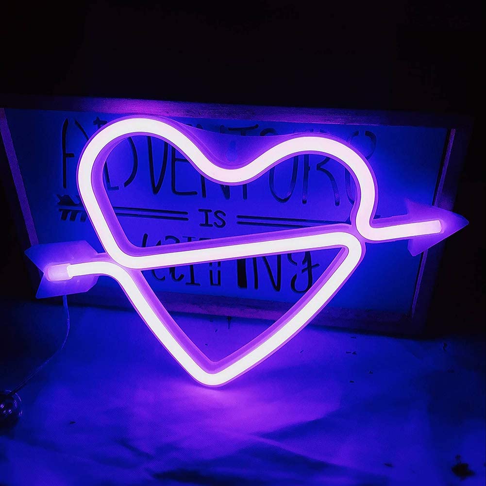Purple heart-and-arrow neon sign displayed on a shelf
