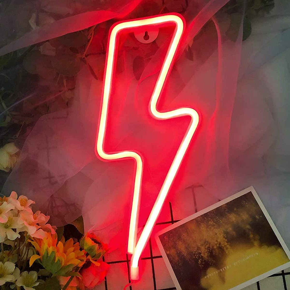 Red lightning bolt neon sign on a decorated wire grid