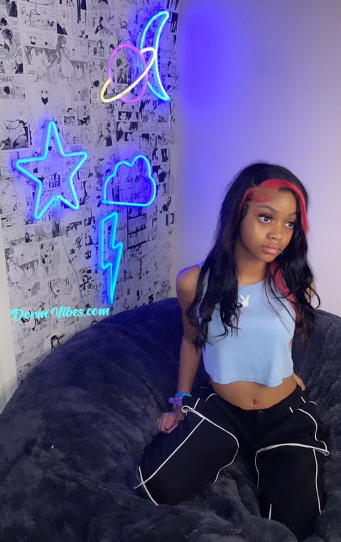 Blue lightning bolt sign among neon wall decorations above a bed