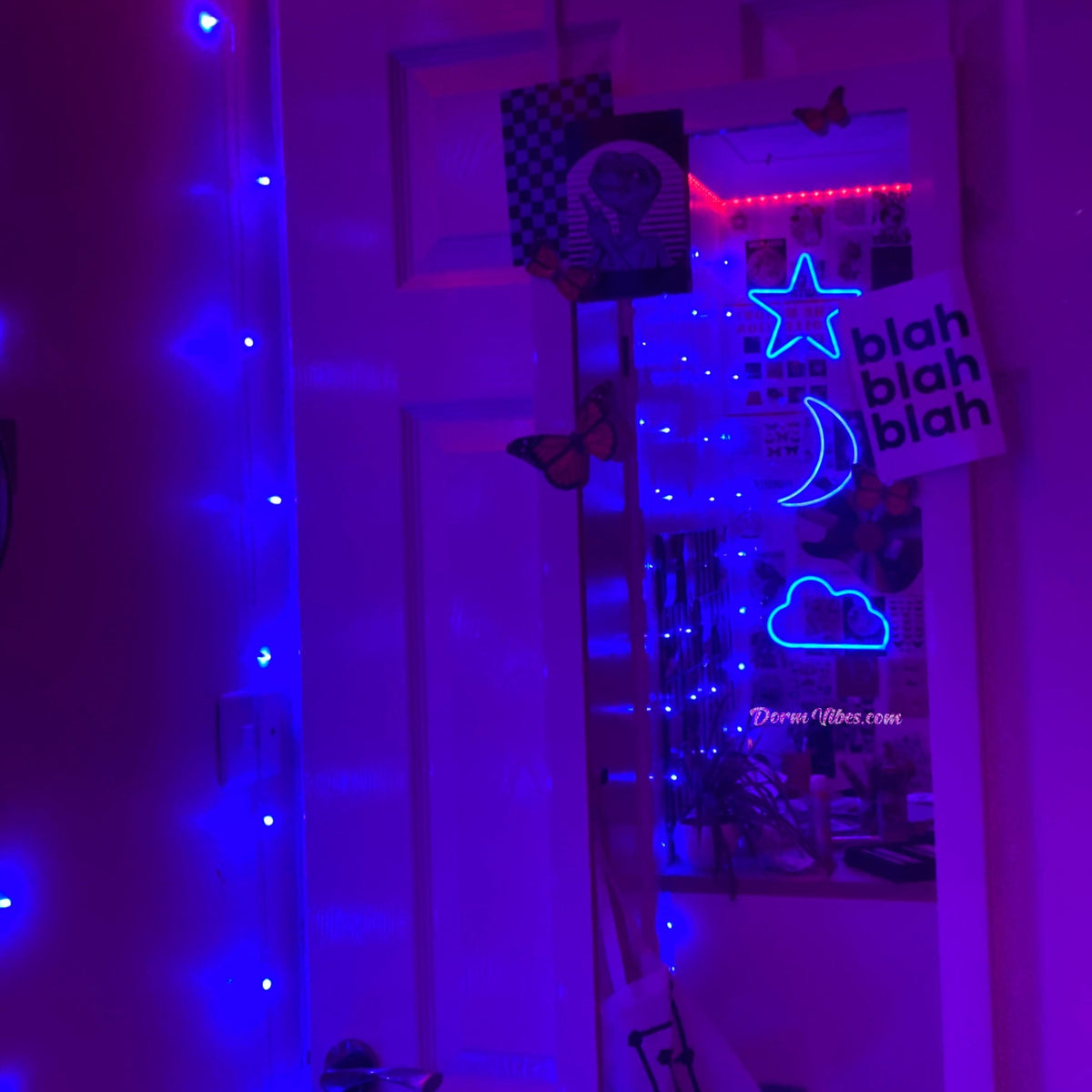 Blue night-sky neon signs reflected in a bedroom mirror