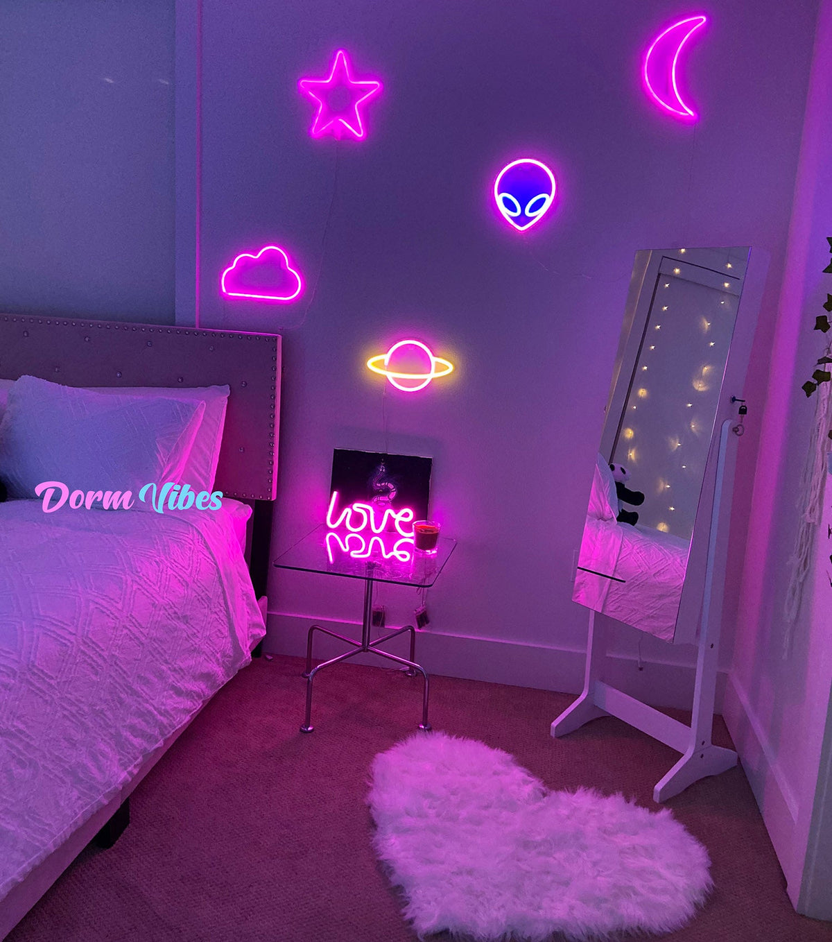 Pink night-sky neon signs above a bed and small side table