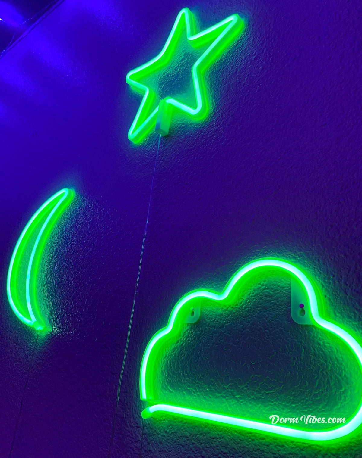Angled view of green cloud, crescent moon and star neon signs