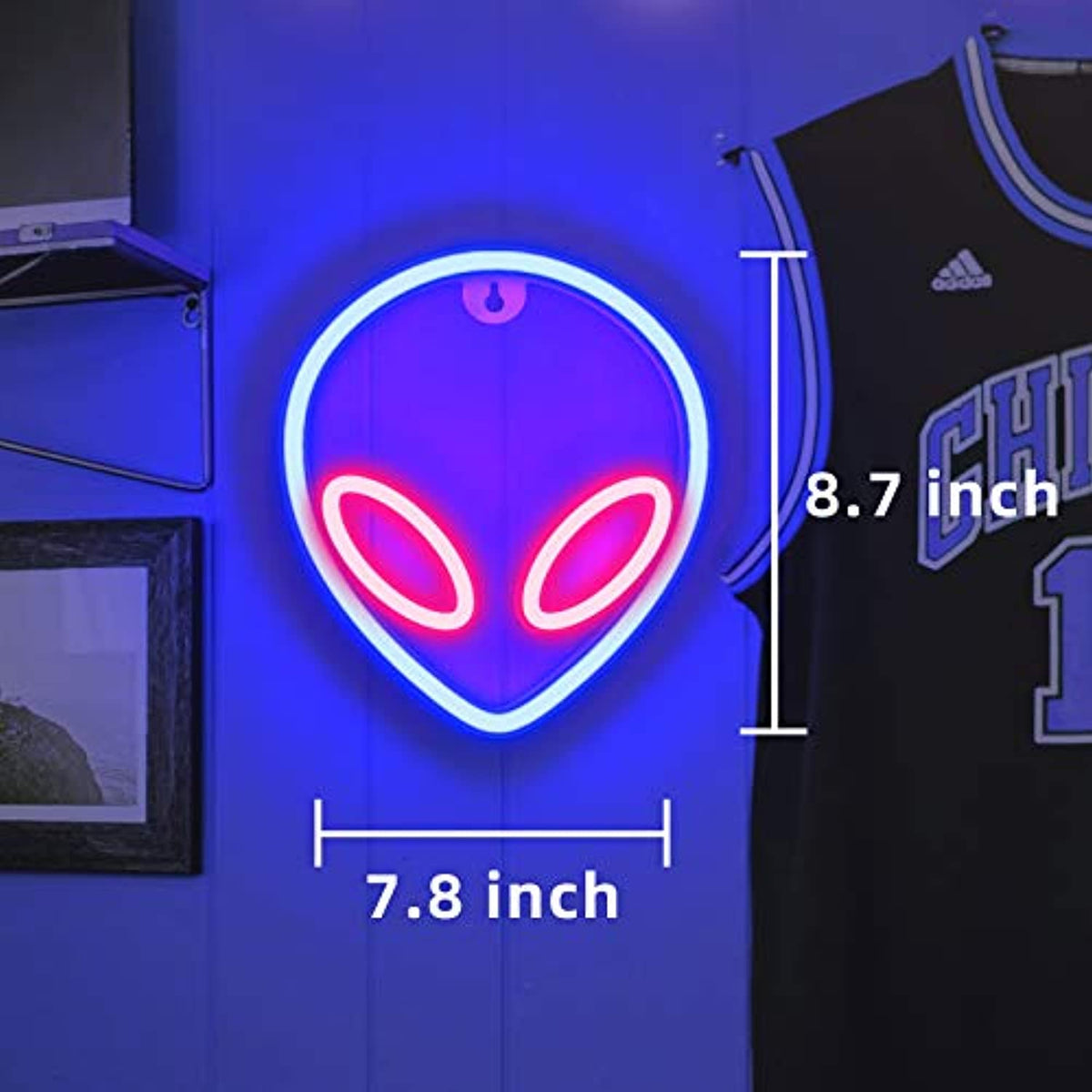 Blue and pink alien head sign with a dimension overlay
