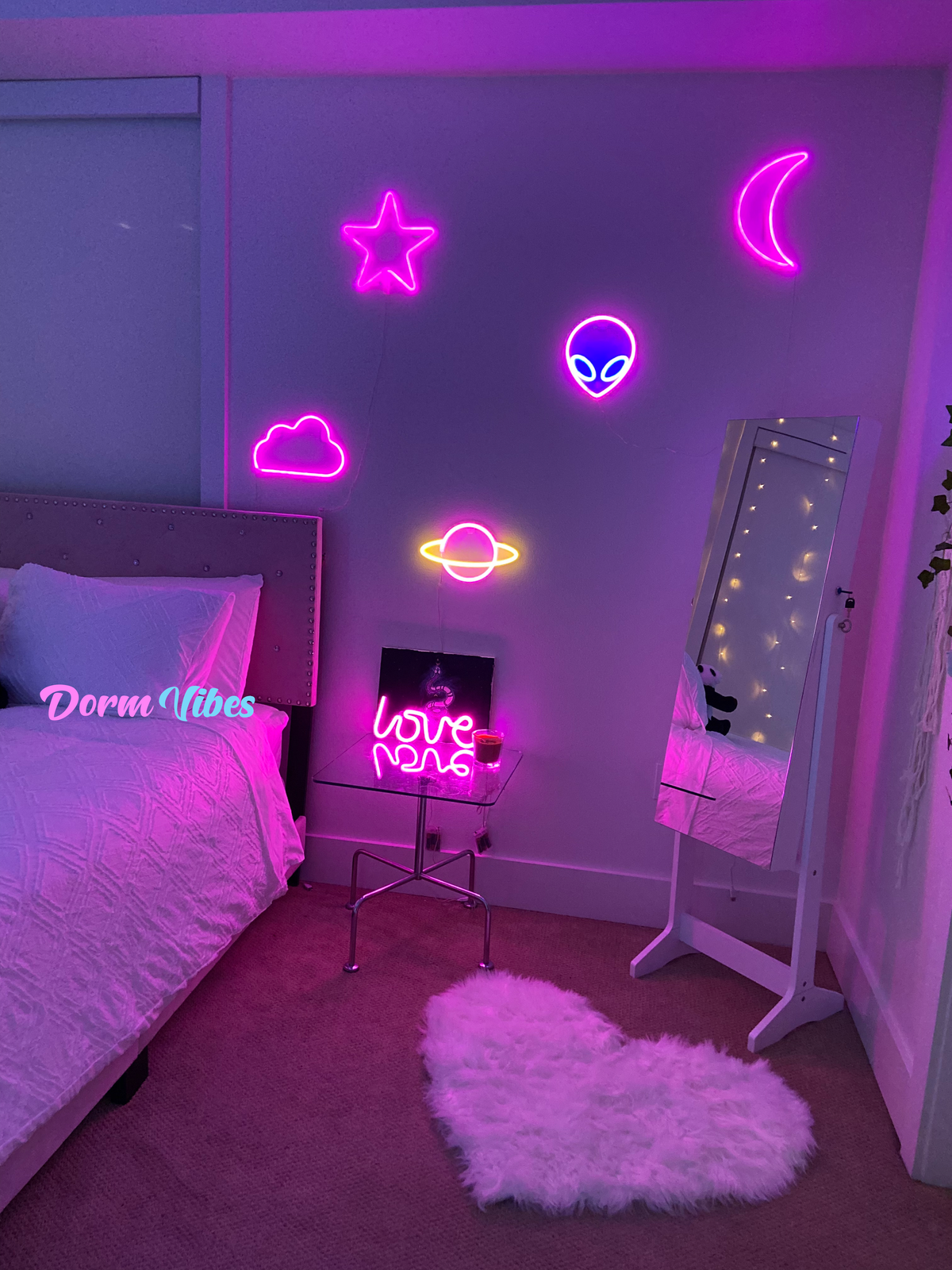 Alien head neon sign among pink bedroom wall decorations