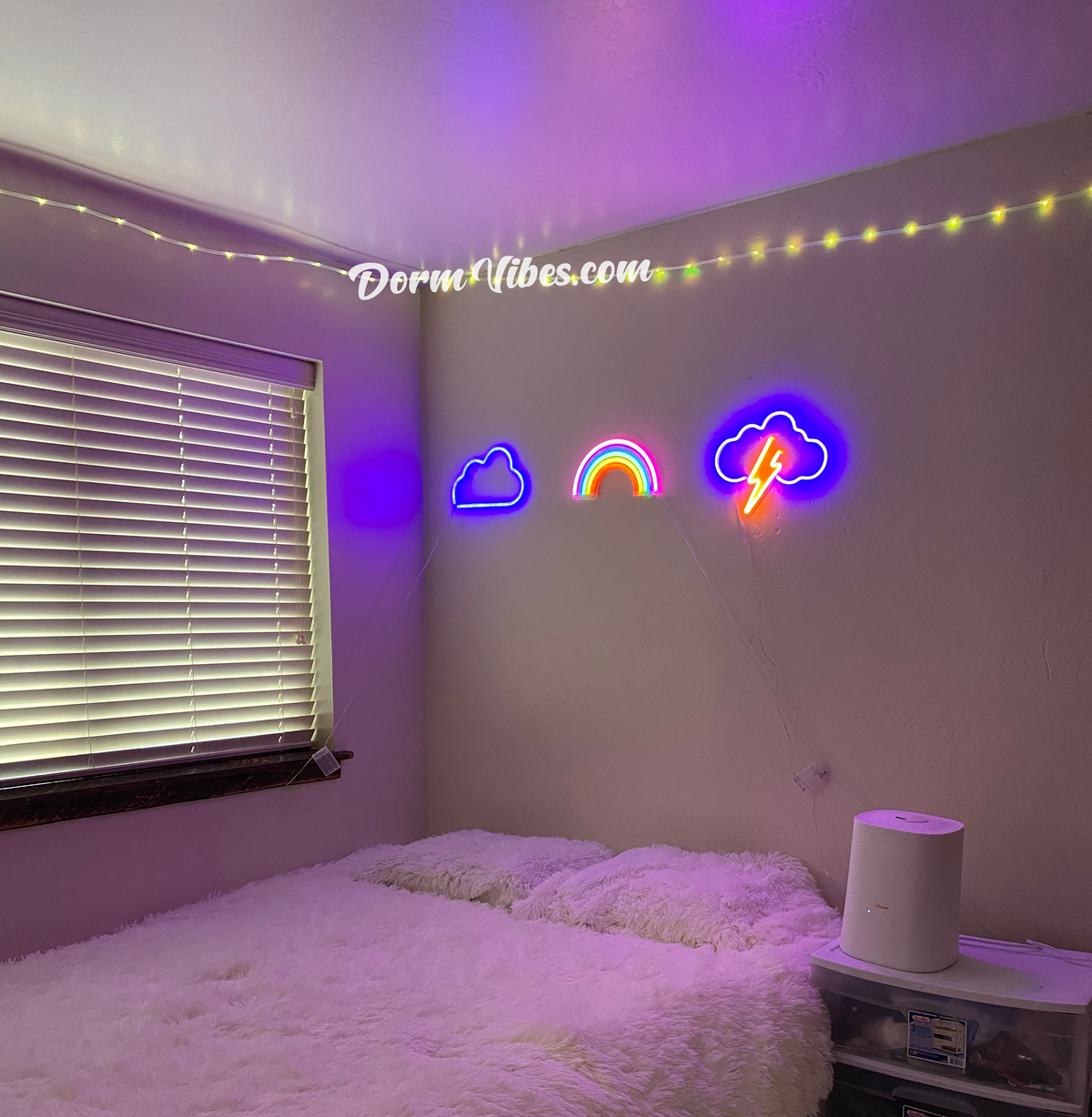 Rainbow neon sign between cloud and lightning signs above a bed