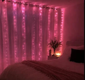 Pink curtain lights illuminating a DormVibes bedroom
