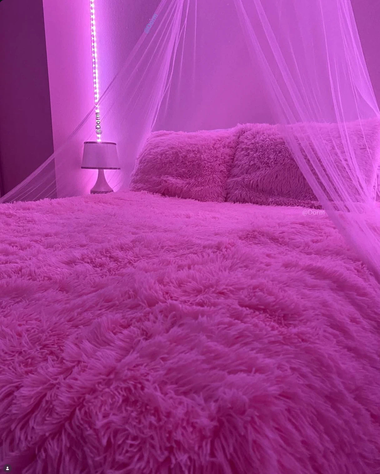 Pink PLUFFY bedding, a sheer canopy, and pink bedroom lights